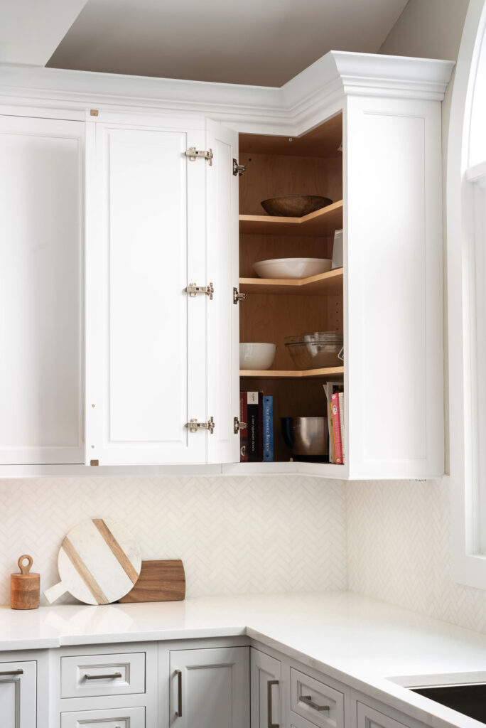 Wellsford Cabinetry Custom Kitchen Framed Plain inset in Designer White Easy Reach Wall Cabinet Bifold Doors Open