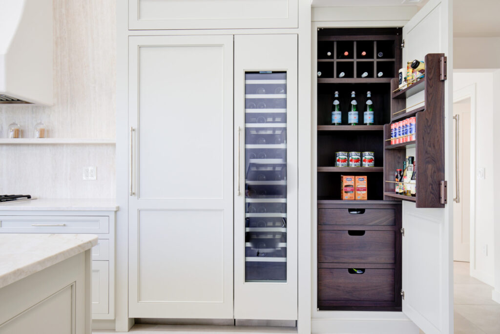 Wellsford Cabinetry Custom Cabinetry Pantry in Walnut Driftwood Fresh Design Group Inc Slab Drawer Fronts with custom notched finger pulls Custom Walnut Spice Rack with brass rods